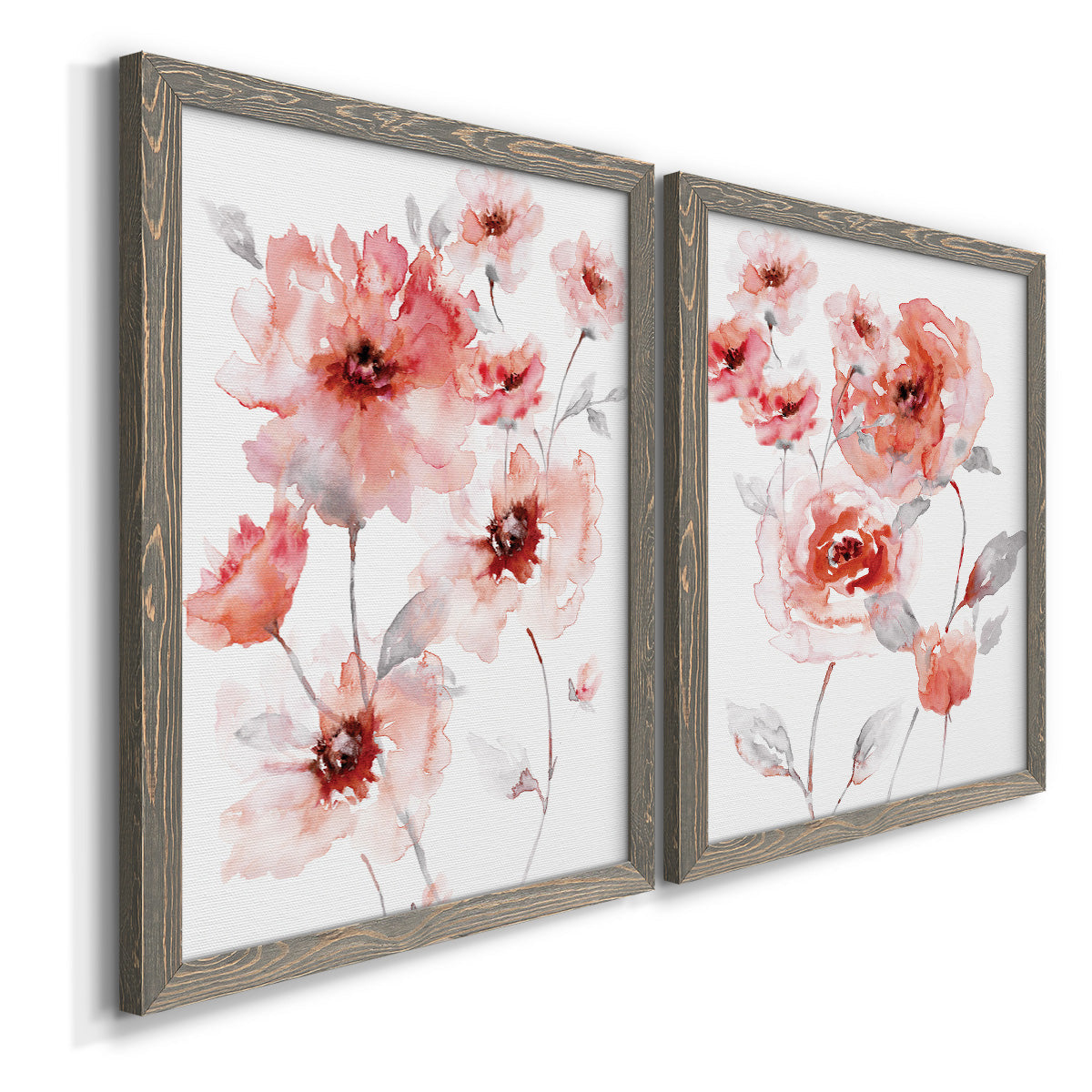 Angled view of a set of two gray barnwood framed canvas prints featuring two airy contemporary watercolor florals featuring loose coral pink blossoms on slender gray stems.