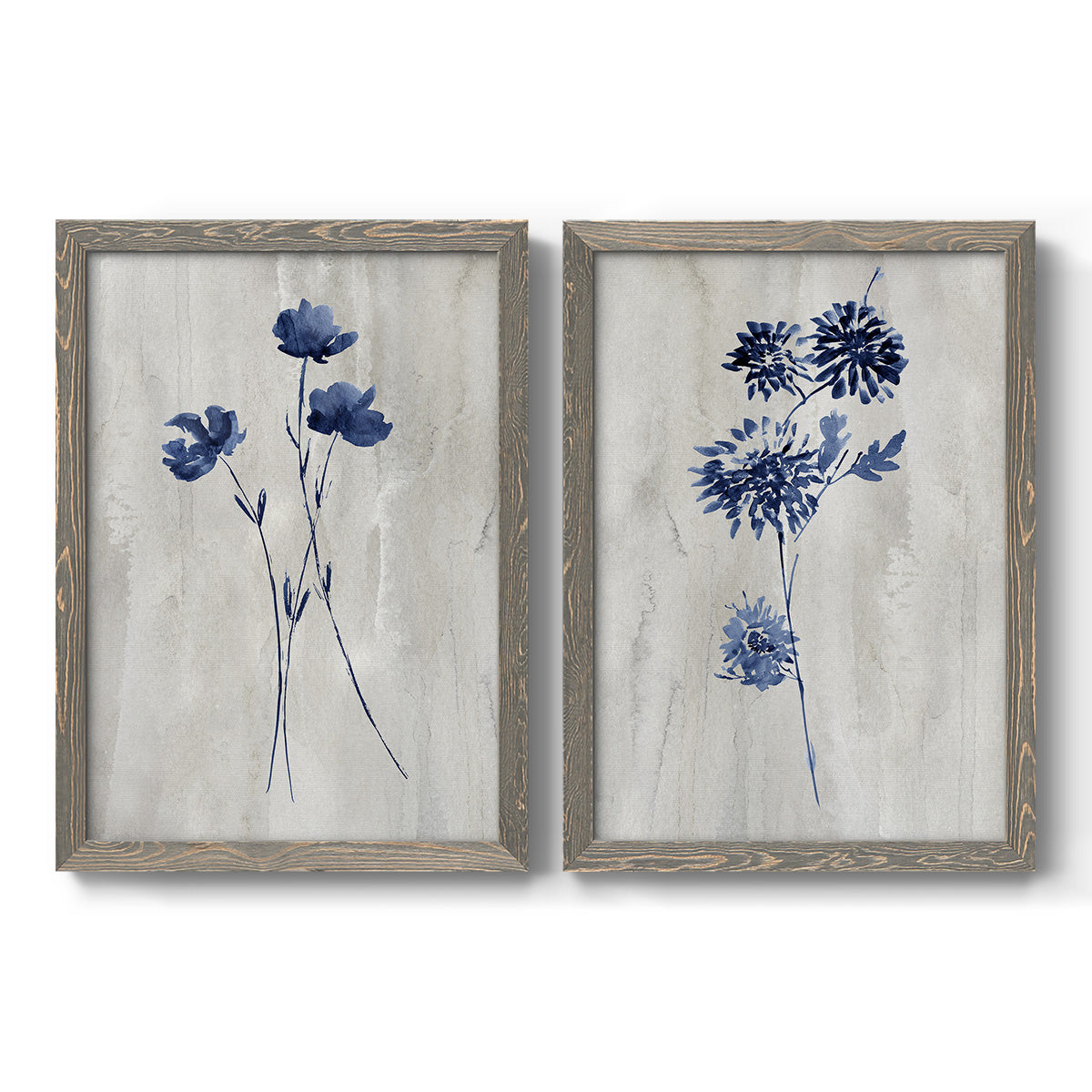 Set of two gray barnwood framed canvas prints featuring two rustic monochrome botanical paintings featuring blue wildflower stems on weathered neutral paper.