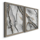 Angled view of a set of two gray barnwood framed canvas prints featuring two marbled alcohol ink abstracts with flowing black gray white and metallic gold veining.