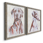 Angled view of a set of two gray barnwood framed canvas prints featuring two traditional watercolor pet paintings featuring gentle seated dog portraits.