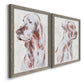 Angled view of a set of two gray barnwood framed canvas prints featuring two traditional watercolor pet paintings featuring gentle seated dog portraits.