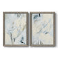 Set of two gray barnwood framed canvas prints featuring two airy gestural abstracts featuring pale blue cream and charcoal marks drifting across white.