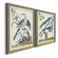 Angled view of a set of two gray barnwood framed canvas prints featuring two antique ornithological plate illustrations featuring vintage exotic birds perched in landscape settings.