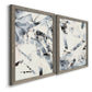 Angled view of a set of two gray barnwood framed canvas prints featuring two high-contrast gestural abstracts featuring angular black and gray brush fragments on white.