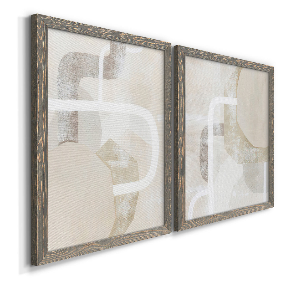 Angled view of a set of two gray barnwood framed canvas prints featuring two neutral geometric abstracts with overlapping rounded forms white lines and soft beige gray textures.