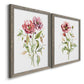 Angled view of a set of two gray barnwood framed canvas prints featuring two traditional watercolor flower studies featuring two airy wildflower stems with pink and burgundy blossoms.
