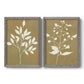 Set of two gray barnwood framed canvas prints featuring two minimalist botanical silhouettes with white leafy stems against warm honey gold backgrounds.