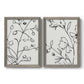 Set of two gray barnwood framed canvas prints featuring two minimalist botanical line art featuring black contour drawings of leaves and flowers.