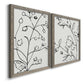 Angled view of a set of two gray barnwood framed canvas prints featuring two minimalist botanical line art featuring black contour drawings of leaves and flowers.