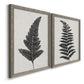 Angled view of a set of two gray barnwood framed canvas prints featuring two minimalist botanical prints featuring black fern leaf silhouettes.