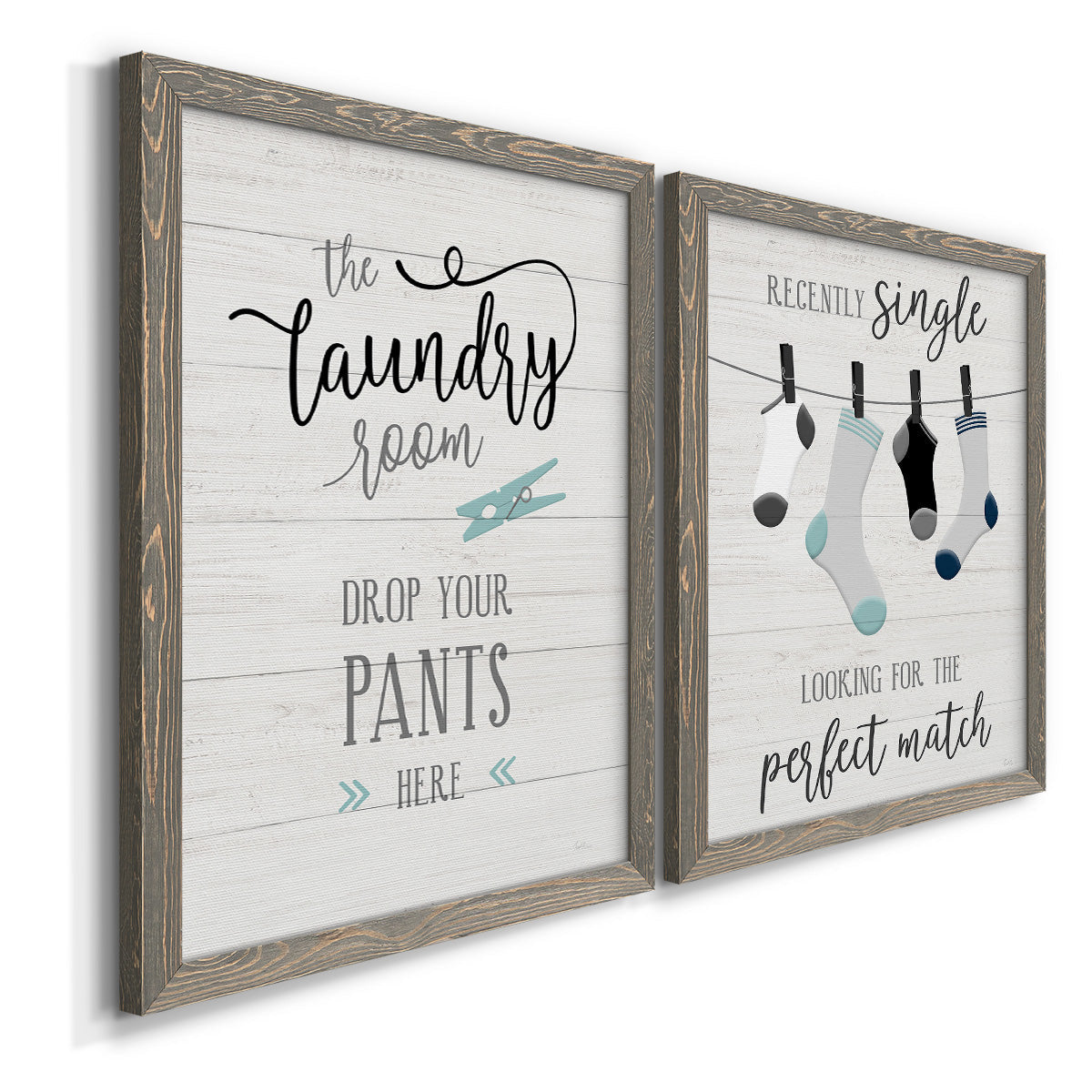 Angled view of a set of two gray barnwood framed canvas prints featuring two rustic typographic wall art featuring humorous laundry-room sayings and clothing icons.