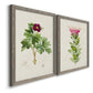 Angled view of a set of two gray barnwood framed canvas prints featuring two vintage botanical plate illustrations featuring pink flowering plant specimens.