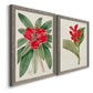 Angled view of a set of two gray barnwood framed canvas prints featuring two antique botanical plate illustrations featuring vivid tropical flowering plants.