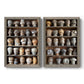 Set of two gray barnwood framed canvas prints featuring two fashion-object photography featuring shelves filled with wooden hat forms.