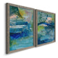 Angled view of a set of two gray barnwood framed canvas prints featuring two energetic mixed-media abstracts featuring layered blue teal green and yellow painterly fields.