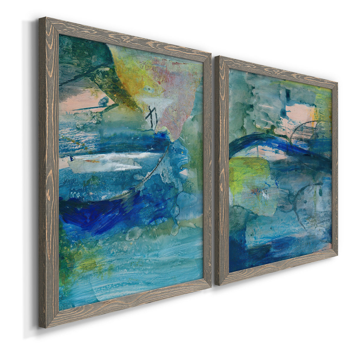 Angled view of a set of two gray barnwood framed canvas prints featuring two energetic mixed-media abstracts featuring layered blue teal green and yellow painterly fields.