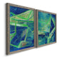 Angled view of a set of two gray barnwood framed canvas prints featuring two textured geometric abstracts featuring interlocking blue and green angular forms.