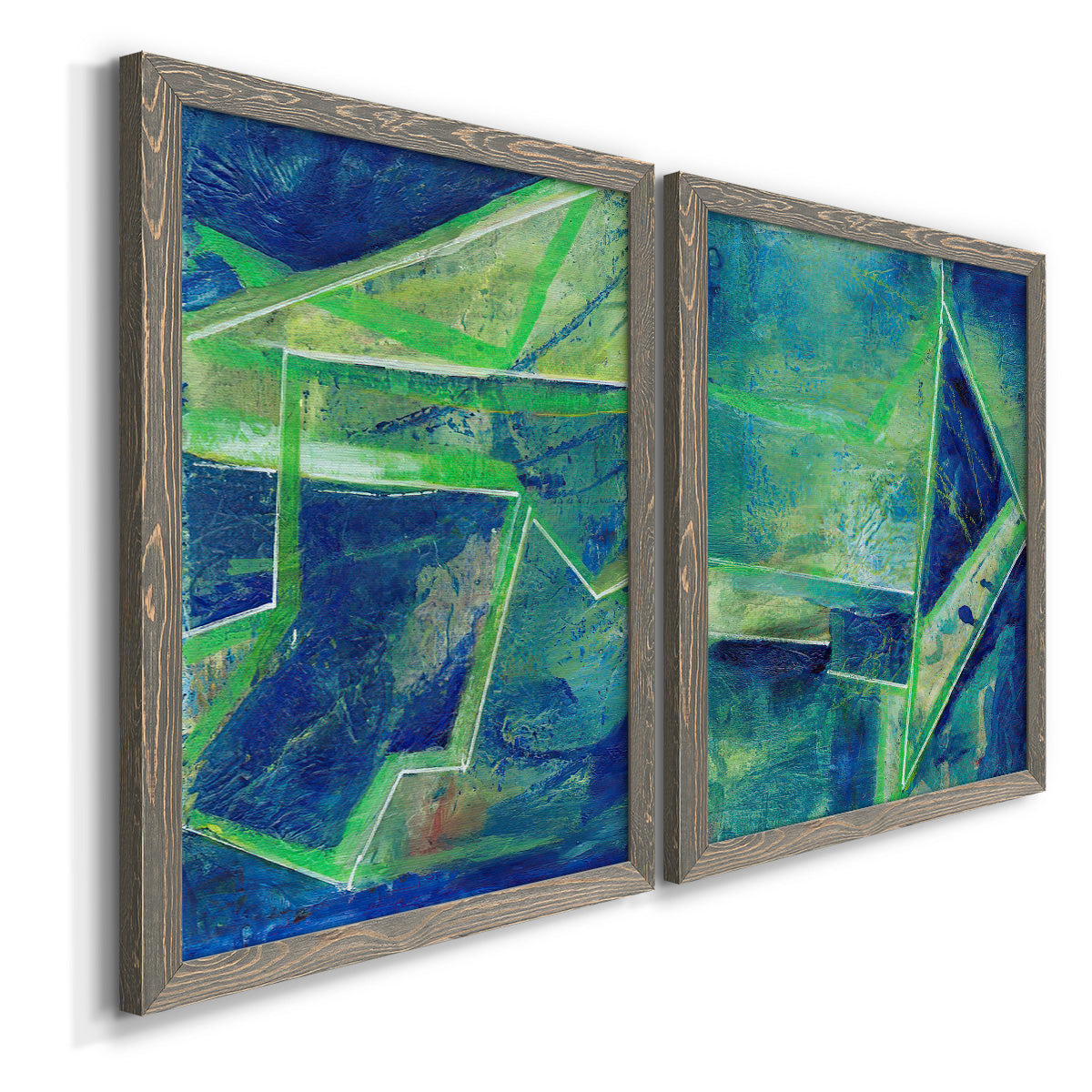 Angled view of a set of two gray barnwood framed canvas prints featuring two textured geometric abstracts featuring interlocking blue and green angular forms.