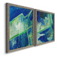 Angled view of a set of two gray barnwood framed canvas prints featuring two textured geometric abstracts featuring interlocking blue and green angular forms.
