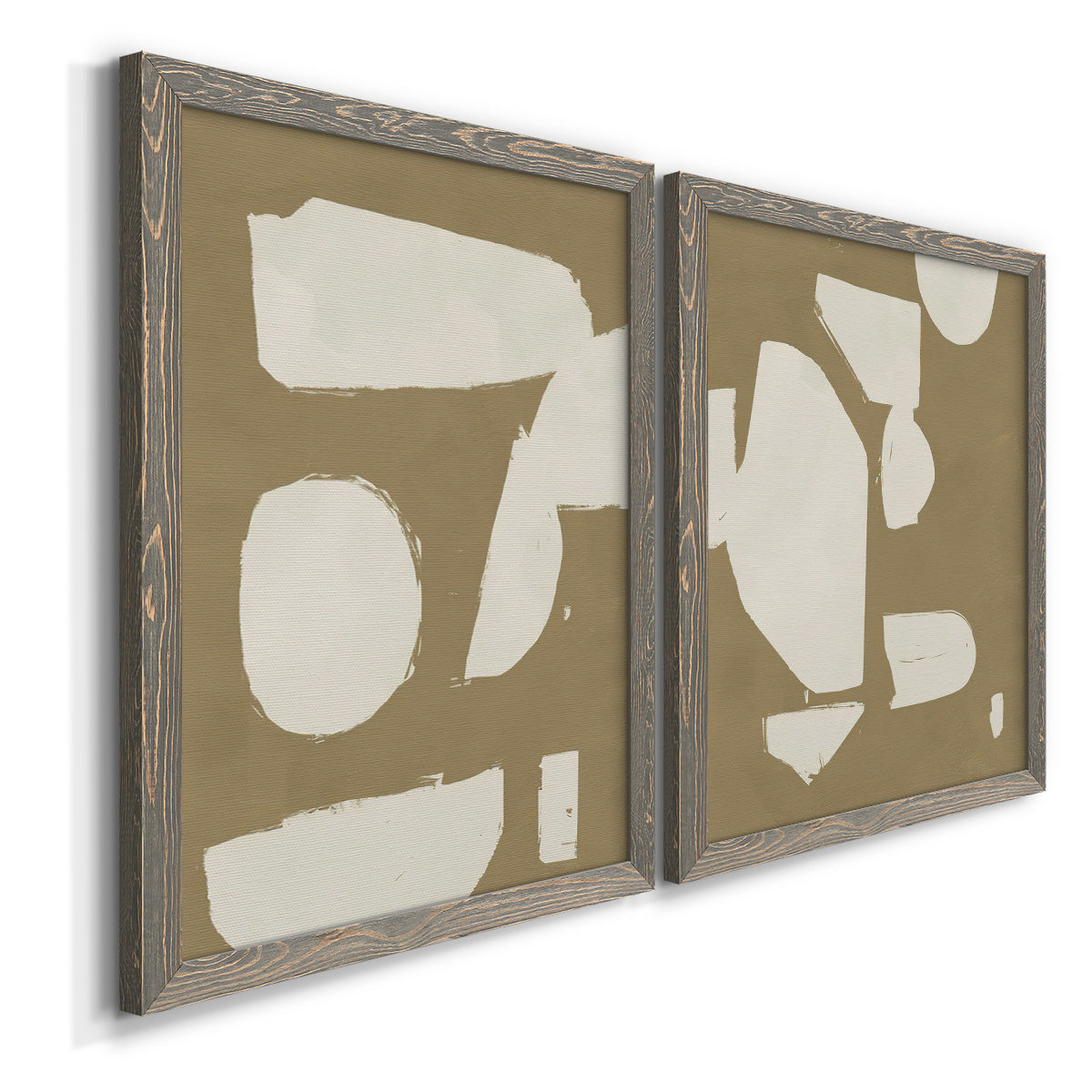 Angled view of a set of two gray barnwood framed canvas prints featuring two bold minimalist shape abstracts featuring irregular white cutout-like shapes on taupe grounds.