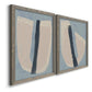 Angled view of a set of two gray barnwood framed canvas prints featuring two minimalist collage-style abstracts featuring single navy brush slashes across layered paper-like shapes.