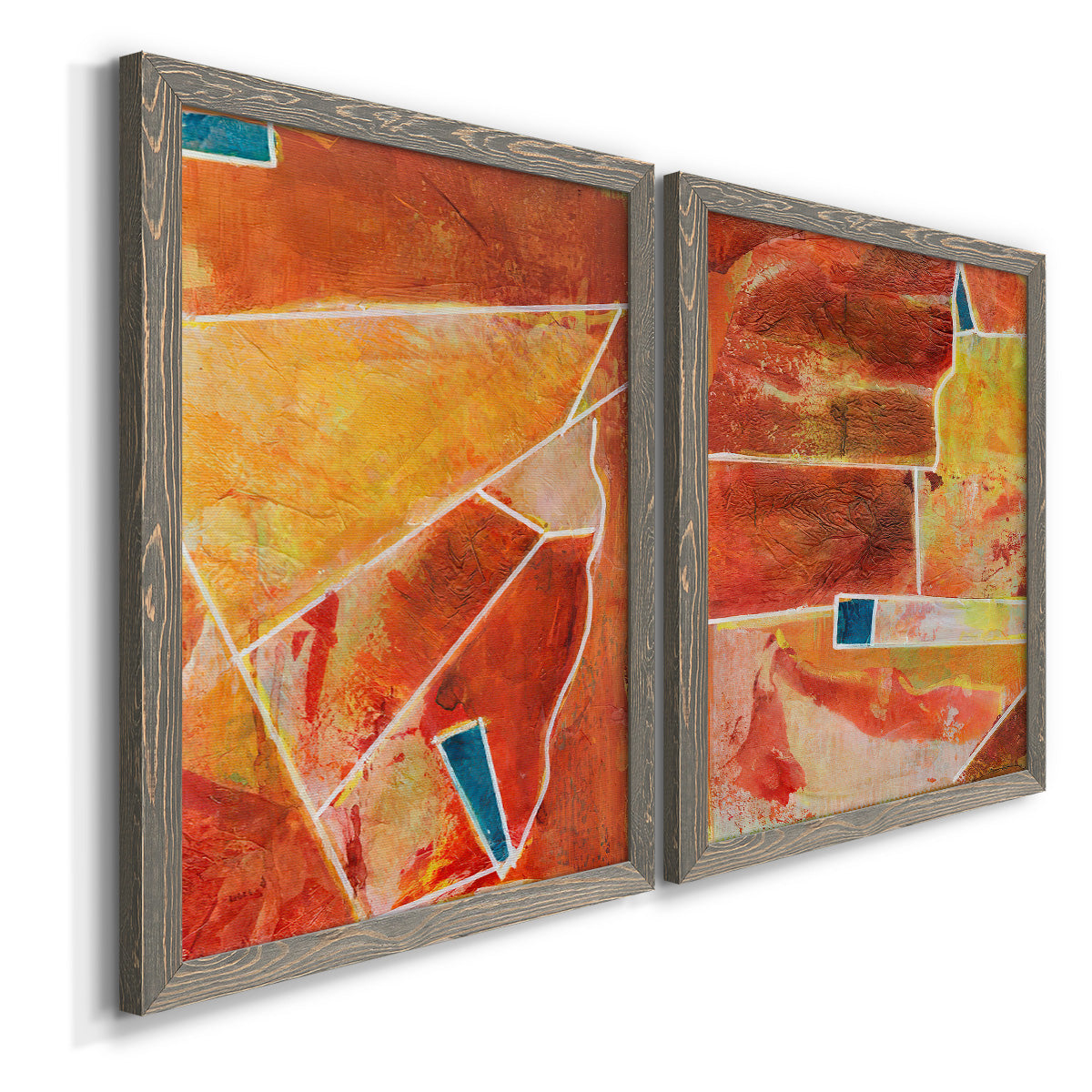 Angled view of a set of two gray barnwood framed canvas prints featuring two warm geometric abstracts featuring faceted rust orange and coral geometric fields.
