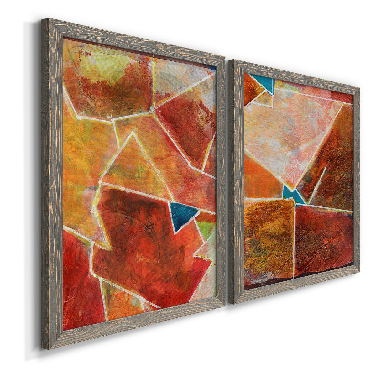 Angled view of a set of two gray barnwood framed canvas prints featuring two warm geometric abstracts featuring faceted rust orange and coral geometric fields.