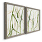 Angled view of a set of two gray barnwood framed canvas prints featuring two fluid organic abstracts featuring branching watercolor lines drifting across white.