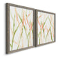 Angled view of a set of two gray barnwood framed canvas prints featuring two fluid organic abstracts featuring branching watercolor lines drifting across white.