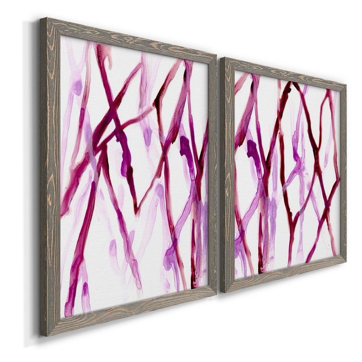 Angled view of a set of two gray barnwood framed canvas prints featuring two fluid organic abstracts featuring branching watercolor lines drifting across white.