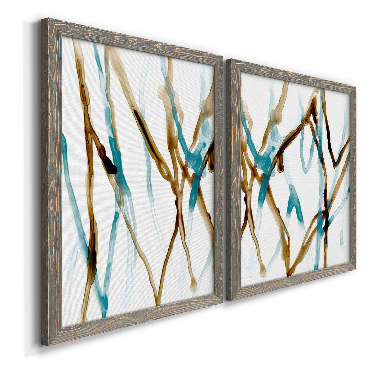 Angled view of a set of two gray barnwood framed canvas prints featuring two fluid abstracts with branching turquoise and brown lines drifting across white backgrounds.
