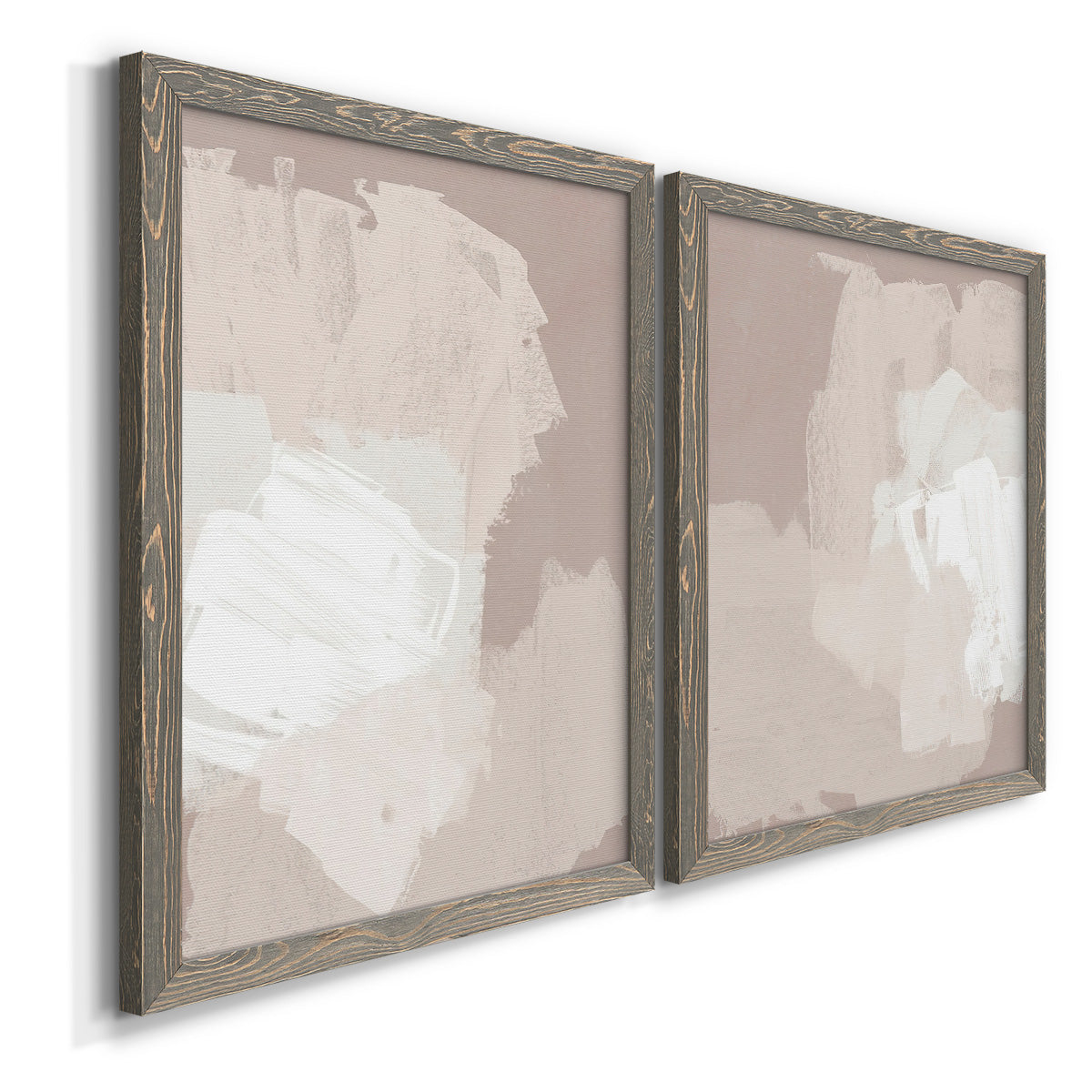 Angled view of a set of two gray barnwood framed canvas prints featuring two neutral minimalist abstracts featuring soft taupe blush and white paint blocks.