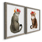 Angled view of a set of two gray barnwood framed canvas prints featuring two whimsical animal portraits featuring seated cats wearing colorful flower crowns.