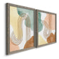 Angled view of a set of two gray barnwood framed canvas prints featuring two folk-inspired botanical patterns featuring repeating indigo floral and leaf motifs.