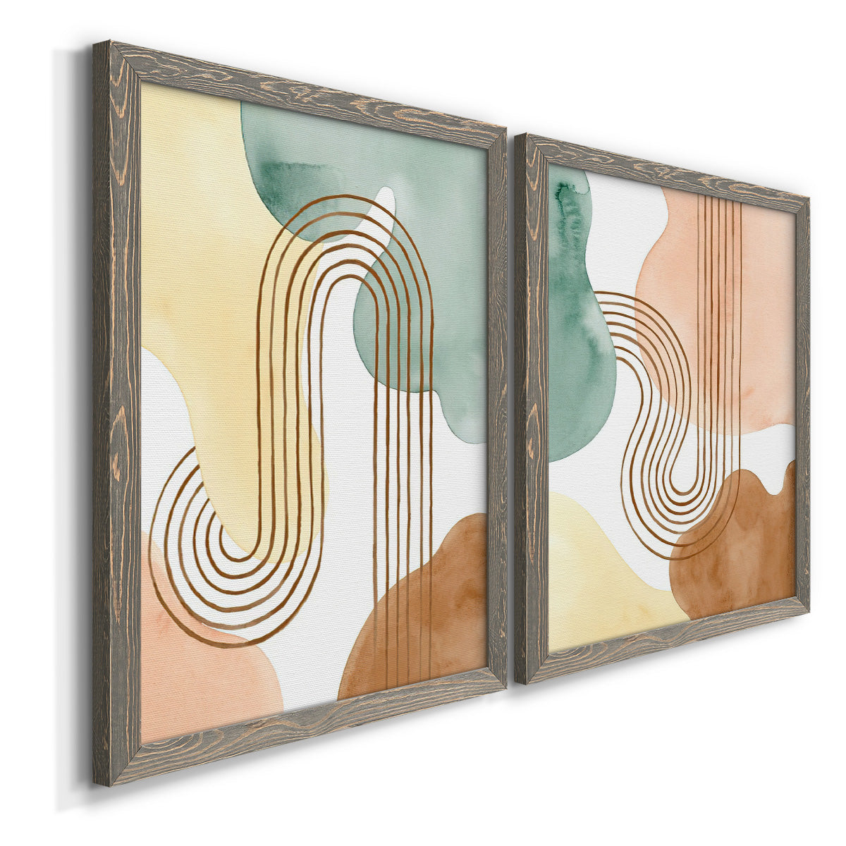 Angled view of a set of two gray barnwood framed canvas prints featuring two folk-inspired botanical patterns featuring repeating indigo floral and leaf motifs.