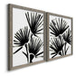 Angled view of a set of two gray barnwood framed canvas prints featuring two bold monochrome botanical prints featuring black fan-shaped botanical forms.