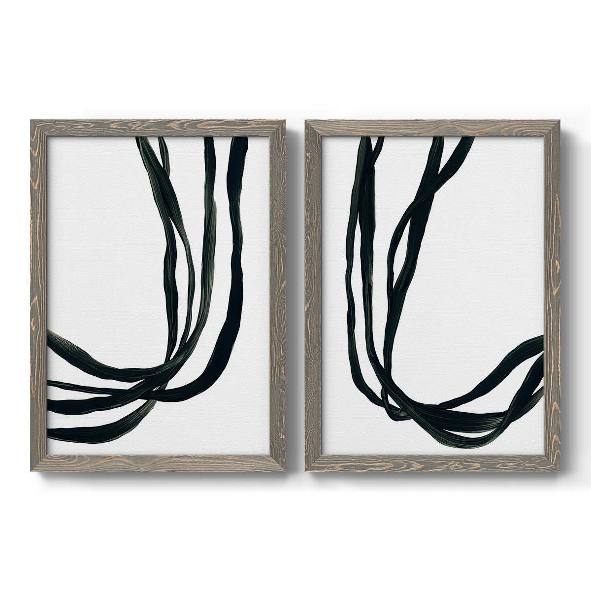 Set of two gray barnwood framed canvas prints featuring two minimalist gestural line abstracts featuring flowing black ribbon-like lines.