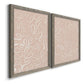Angled view of a set of two gray barnwood framed canvas prints featuring two graphic botanical pattern abstracts featuring continuous white organic lines over solid ochre and blush fields.