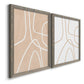 Angled view of a set of two gray barnwood framed canvas prints featuring two minimalist line abstracts featuring single continuous tan lines forming oversized organic curves.