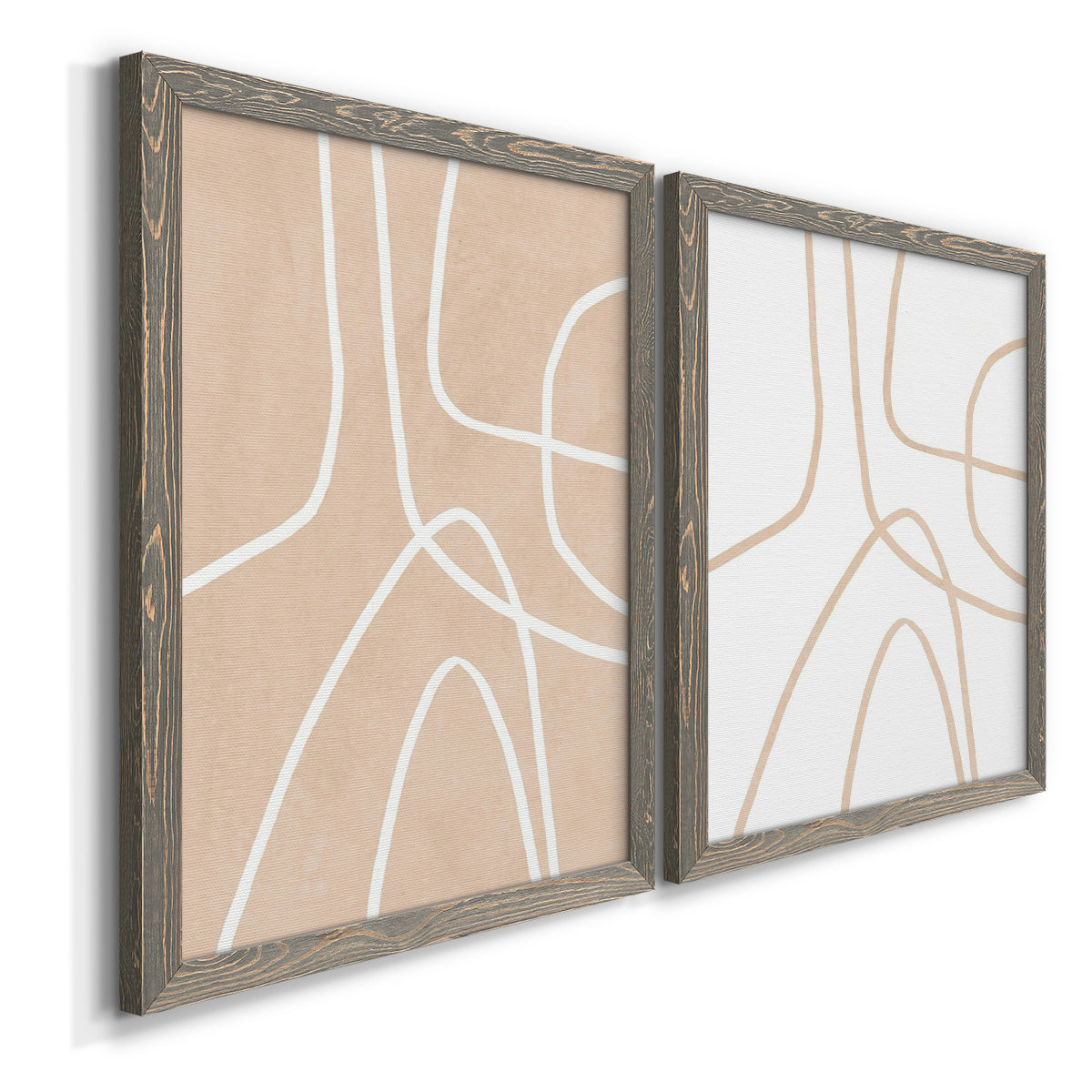 Angled view of a set of two gray barnwood framed canvas prints featuring two minimalist line abstracts featuring single continuous tan lines forming oversized organic curves.