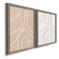 Angled view of a set of two gray barnwood framed canvas prints featuring two minimalist line abstracts featuring single continuous tan lines forming oversized organic curves.