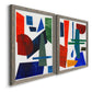 Angled view of a set of two gray barnwood framed canvas prints featuring two mid-century graphic abstracts featuring bold red blue green yellow and black geometric forms.
