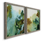 Angled view of a set of two gray barnwood framed canvas prints featuring two organic watercolor abstracts featuring fluid green blue and earthy brown ink pools.
