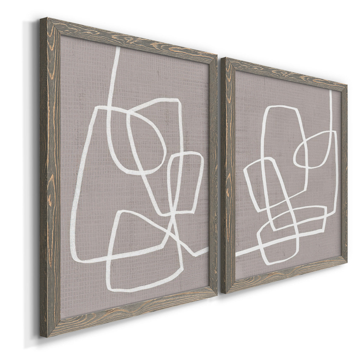 Angled view of a set of two gray barnwood framed canvas prints featuring two minimalist geometric line art featuring overlapping white continuous-line loops on taupe.