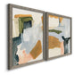 Angled view of a set of two gray barnwood framed canvas prints featuring two contemporary mixed-media abstracts featuring layered green ochre blush gray and white paint blocks.