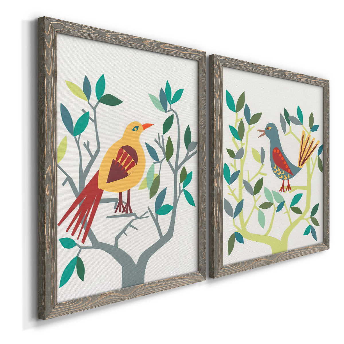 Angled view of a set of two gray barnwood framed canvas prints featuring two modern folk-art bird illustrations featuring stylized colorful birds perched among leafy branches.