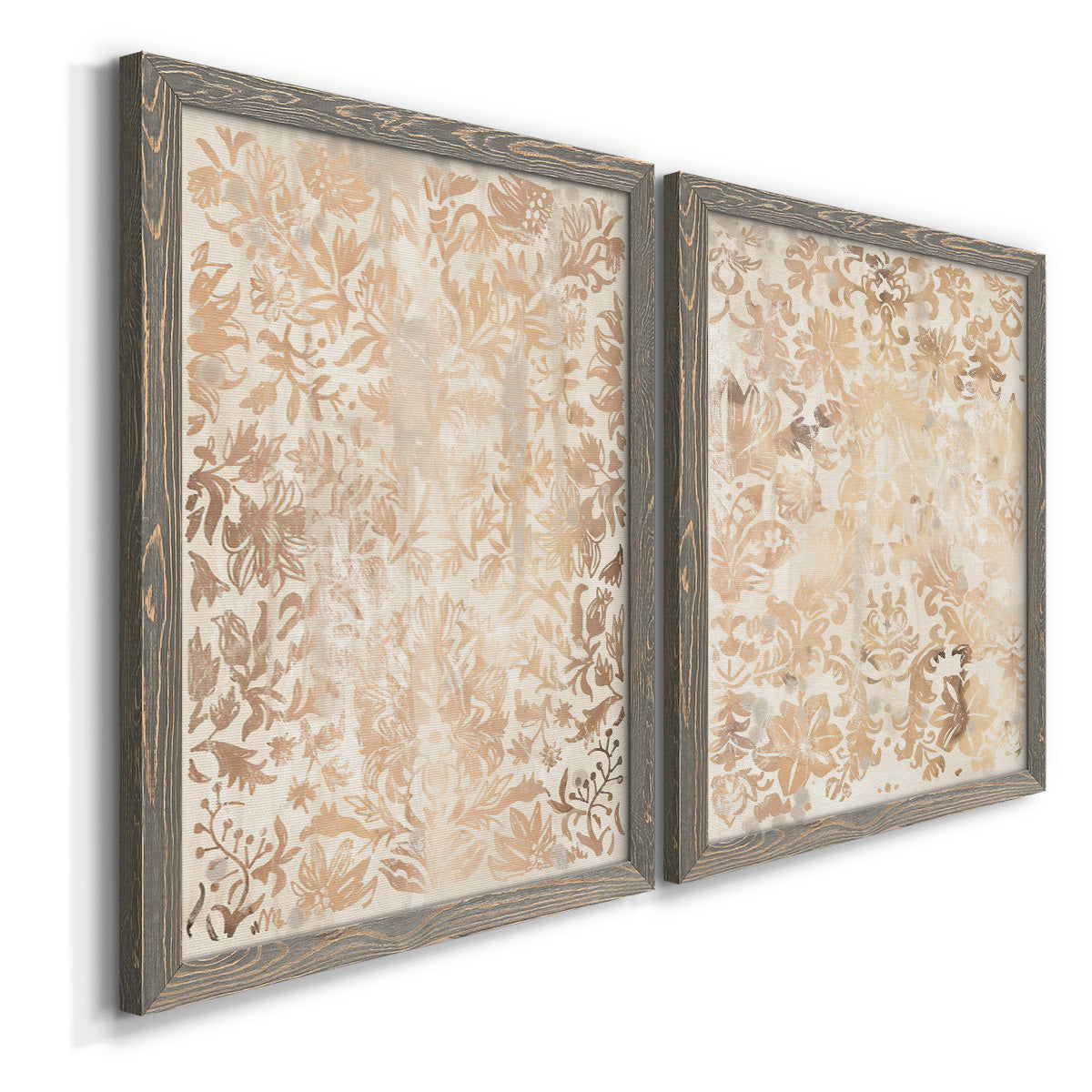 Angled view of a set of two gray barnwood framed canvas prints featuring two vintage decorative prints featuring ornate cream floral damask patterns.
