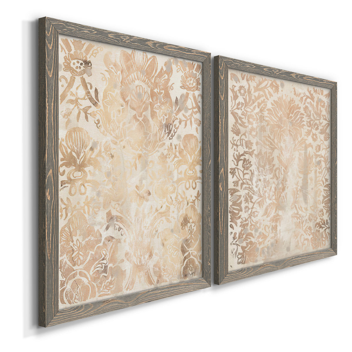 Angled view of a set of two gray barnwood framed canvas prints featuring two vintage decorative prints featuring ornate cream floral damask patterns.