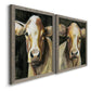 Angled view of a set of two gray barnwood framed canvas prints featuring two painterly farm-animal portraits featuring close-up portraits of gentle brown cows.