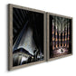 Angled view of a set of two gray barnwood framed canvas prints featuring two vintage architectural illustrations featuring dramatic Art Deco city and theater scenes.